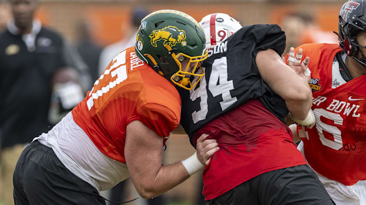 Jan 30, 2025; Mobile, AL, USA; National team offensive lineman Grey Zabel of North Dakota State (77) and National team offensive lineman Caleb Rogers of Texas Tech (76) battle with National team defensive lineman Ty Robinson of Nebraska (94) during Senior Bowl practice for the National team at Hancock Whitney Stadium. Mandatory Credit: Vasha Hunt-Imagn Images Jan 30, 2025; Mobile, AL, USA; National team offensive lineman Grey Zabel of North Dakota State (77) and National team offensive lineman Caleb Rogers of Texas Tech (76) battle with National team defensive lineman Ty Robinson of Nebraska (94) during Senior Bowl practice for the National team at Hancock Whitney Stadium. Mandatory Credit: Vasha Hunt-Imagn Images