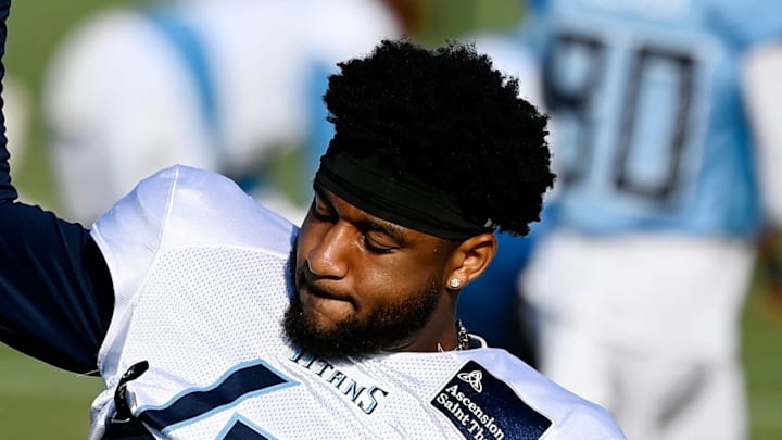 Tennessee Titans safety Mike Brown stretches during an NFL football training camp practice. Tennessee Titans safety Mike Brown stretches during an NFL football training camp practice.