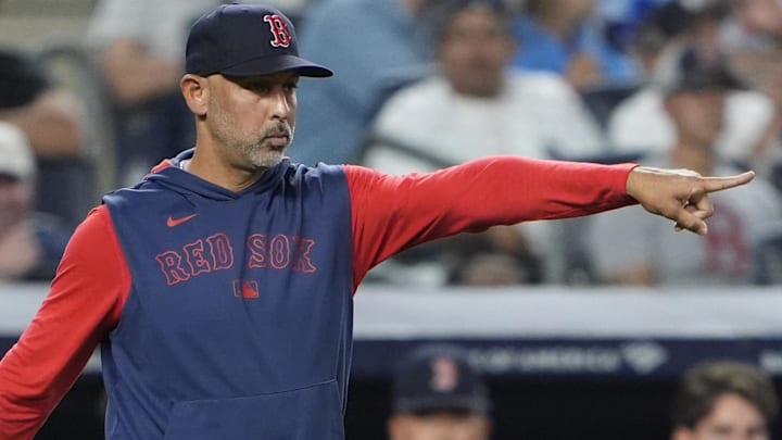 Aug 22, 2025; Bronx, New York, USA; Boston Red Sox manager Alex Cora (13) signals to the umpire that he is checking on Boston Red Sox pitcher Garrett Whitlock (22) (not pictured) to see that he is alright to continue during the eighth inning against the New York Yankees at Yankee Stadium.
