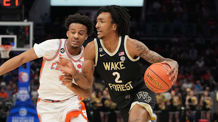 Mar 11, 2026; Charlotte, NC, USA; Wake Forest Demon Deacons forward Juke Harris (2) with the ball as Clemson Tigers guard Efrem Johnson (4) defends in the first half at Spectrum Center. Mandatory Credit: Bob Donnan-Imagn Images