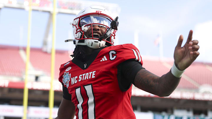 Dec 19, 2025; Tampa, FL, USA; NC State Wolfpack quarterback CJ Bailey (11) runs into the end zone for a touchdown against the Memphis Tigers in the first quarter during the Gasparilla Bowl at Raymond James Stadium. Mandatory Credit: Nathan Ray Seebeck-Image Images