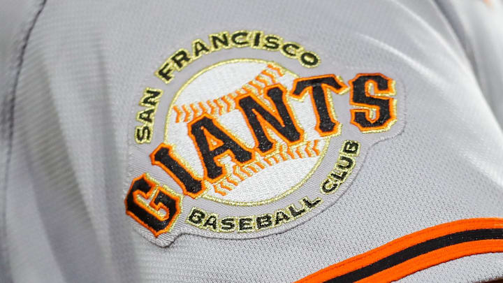 A San Francisco Giants logo on the side of a gray uniform. 