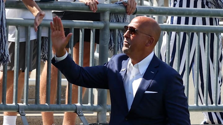 Penn State Nittany Lions head coach James Franklin shakes hands with students