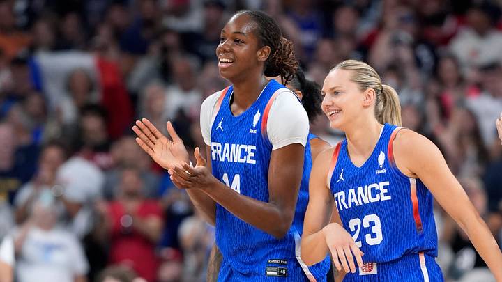 Jul 29, 2024; Villeneuve-d'Ascq, France; France center Dominique Malonga (14) and guard Marine Johannes (23) celebrate after defeating Canada during the Paris 2024 Olympic Summer Games at Stade Pierre-Mauroy. Mandatory Credit: John David Mercer-USA TODAY Sports