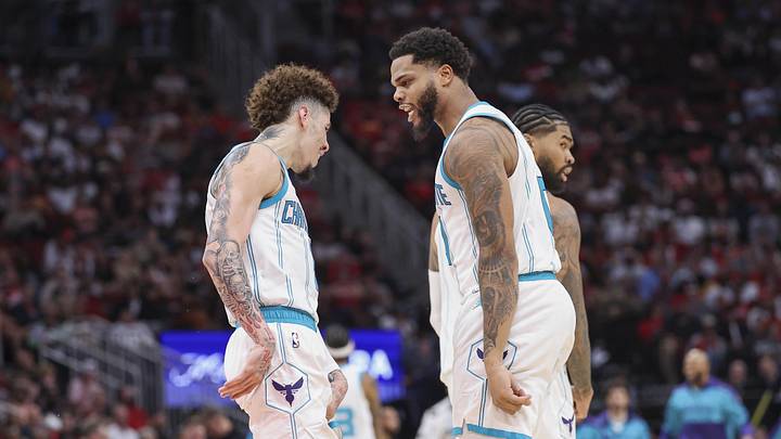 Charlotte Hornets forward Miles Bridges celebrates with guard LaMelo Ball after scoring a basket during the fourth quarter against the Houston Rockets at Toyota Center.