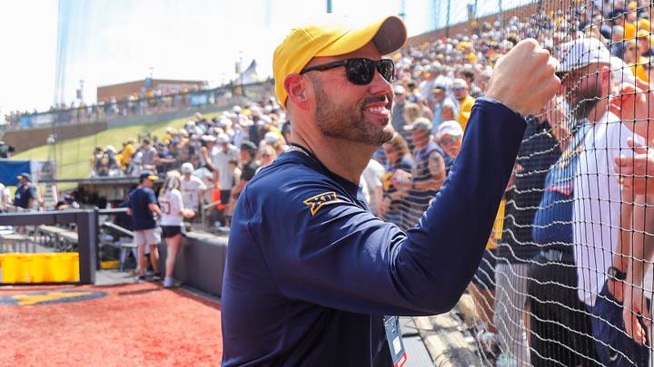 Jun 5, 2026; Morgantown, WV, USA; West Virginia Mountaineers athletic director Wren Baker celebrates with Pat McAfee after defeating the Cal Poly Mustangs at Kendrick Family Ballpark. Mandatory Credit: Ben Queen-Imagn Images Jun 5, 2026; Morgantown, WV, USA; West Virginia Mountaineers athletic director Wren Baker celebrates with Pat McAfee after defeating the Cal Poly Mustangs at Kendrick Family Ballpark. Mandatory Credit: Ben Queen-Imagn Images