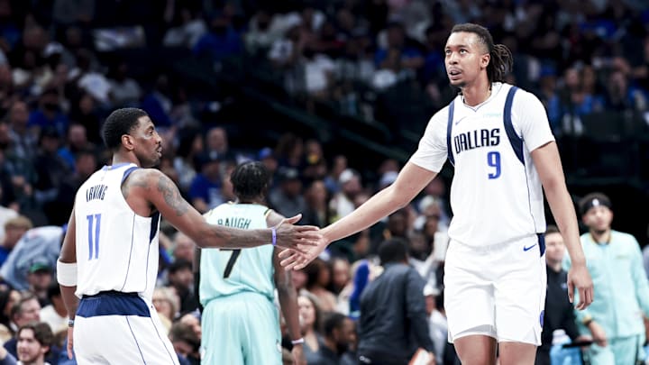 Feb 27, 2025; Dallas, Texas, USA; Dallas Mavericks center Moses Brown (9) celebrates with Dallas Mavericks guard Kyrie Irving (11) against the Charlotte Hornets during the first half at American Airlines Center. Mandatory Credit: Kevin Jairaj-Imagn Images