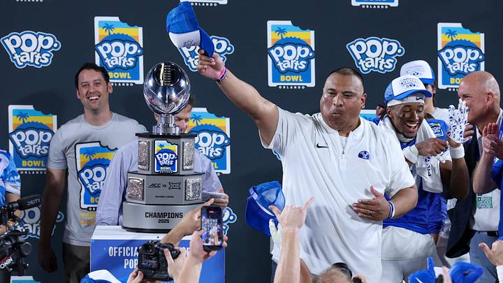 Dec 27, 2025; Orlando, FL, USA; BYU Cougars head coach Kalani Sitake celebrates after beating Georgia Tech Yellow Jackets in the Pop-Tarts Bowl at Camping World Stadium. Mandatory Credit: Nathan Ray Seebeck-Imagn Images