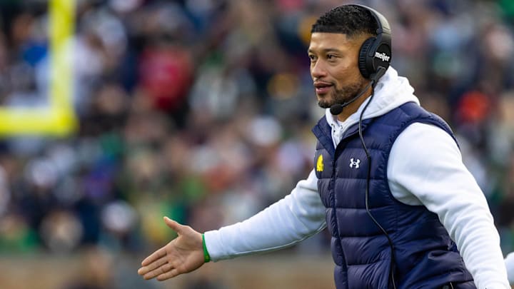 Nov 22, 2025; South Bend, Indiana, USA; Notre Dame Fighting Irish head coach Marcus Freeman celebrates with players after scoring against the Syracuse Orange during the first half at Notre Dame Stadium. 