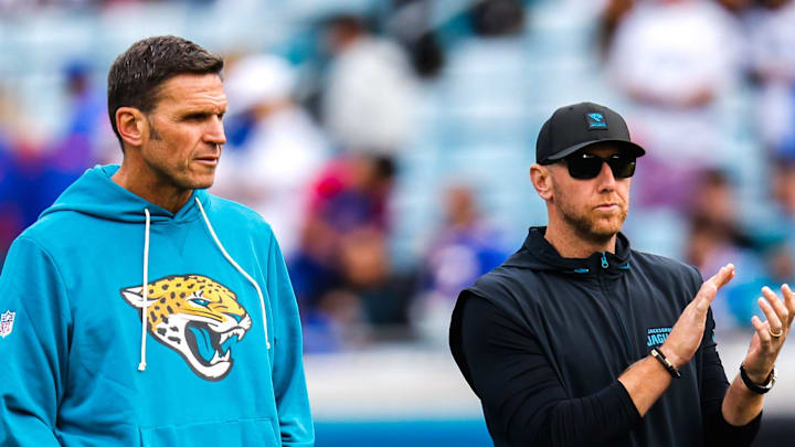 Jacksonville Jaguars Executive Vice President of Football Operations Tony Boselli, left and Jacksonville Jaguars head coach Liam Coen watch warm up before an NFL football AFC Wild Card playoff matchup, Sunday, Jan. 11, 2026, in Jacksonville, Fla. Bills lead 10-7 at the half over the Jaguars. [Doug Engle/Florida Times-Union]