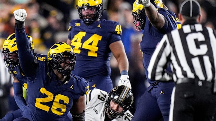 Michigan defensive lineman Rayshaun Benny (26) celebrates against tackle against Purdue quarterback Malachi Singleton (3) during the second half at Michigan Stadium in Ann Arbor on Saturday, November 1, 2025. Michigan defensive lineman Rayshaun Benny (26) celebrates against tackle against Purdue quarterback Malachi Singleton (3) during the second half at Michigan Stadium in Ann Arbor on Saturday, November 1, 2025.