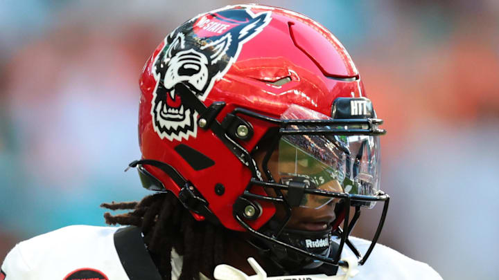 Nov 15, 2025; Miami Gardens, Florida, USA; NC State Wolfpack quarterback CJ Bailey (11) looks for a passing option against the Miami Hurricanes during the second quarter at Hard Rock Stadium. Mandatory Credit: Sam Navarro-Imagn Images