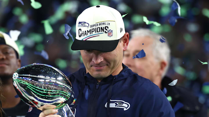Feb 8, 2026; Santa Clara, CA, USA; Seattle Seahawks head coach Mike MacDonald celebrates with the Vince Lombardi trophy on the podium after defeating the New England Patriots in Super Bowl LX at Levi's Stadium. Mandatory Credit: Mark J. Rebilas-Imagn Images