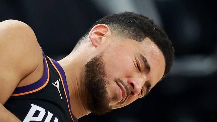 Phoenix Suns guard Devin Booker (1) reacts after suffering an injury against the Washington Wizards in the first half at Mortgage Matchup Center on Jan 11, 2026. Phoenix Suns guard Devin Booker (1) reacts after suffering an injury against the Washington Wizards in the first half at Mortgage Matchup Center on Jan 11, 2026.
