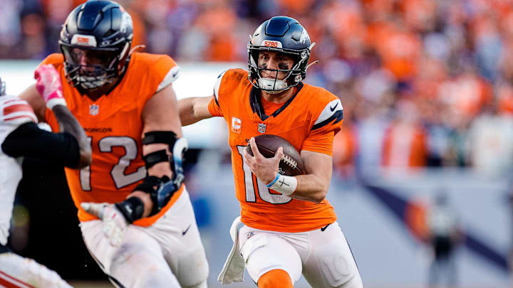 Oct 19, 2025; Denver, Colorado, USA; Denver Broncos quarterback Bo Nix (10) runs for a touchdown as offensive tackle Garett Bolles (72) defends against New York Giants cornerback Deonte Banks (2) in the fourth quarter at Empower Field at Mile High. 