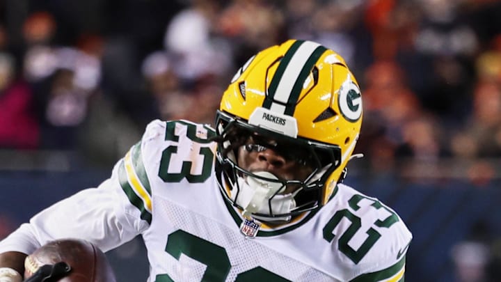 Green Bay Packers running back Emanuel Wilson runs with the ball against Chicago Bears cornerback Tyrique Stevenson