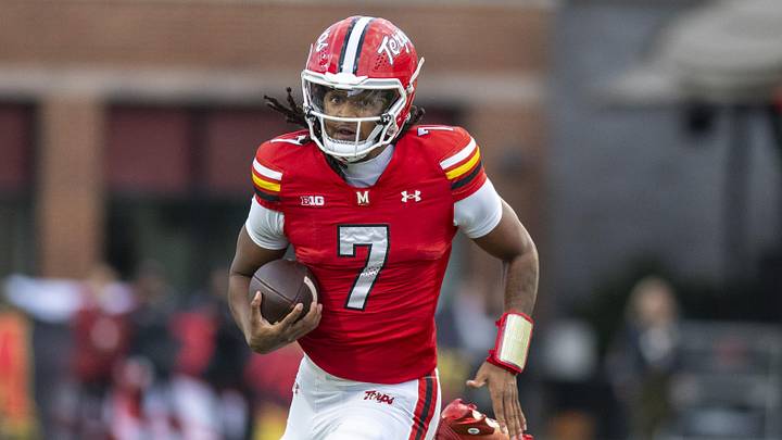 Maryland Terrapins quarterback Malik Washington scrambles against the Michigan Wolverines. Maryland Terrapins quarterback Malik Washington scrambles against the Michigan Wolverines.