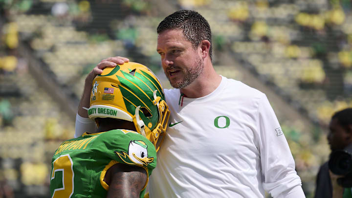 Oregon Ducks head coach Dan Lanning talks to wide receiver Gary Bryant Jr. during warm ups before a game against the Montana State Bobcats.