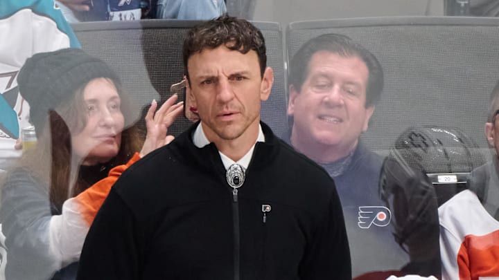 Dec 31, 2024; San Jose, California, USA; Philadelphia Flyers assistant coach Rocky Thompson watches game play against the San Jose Sharks during the third period at SAP Center at San Jose. Mandatory Credit: Robert Edwards-Imagn Images