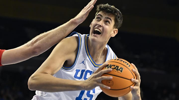 Nov 11, 2024; Los Angeles, California, USA;  UCLA Bruins center Aday Mara (15) drives to the basket on Boston University Terriers forward Nico Nobili (21) during the second half at Pauley Pavilion presented by Wescom. Mandatory Credit: Robert Hanashiro-Imagn Images



