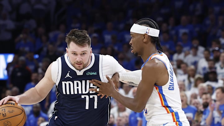May 7, 2024; Oklahoma City, Oklahoma, USA; Dallas Mavericks guard Luka Doncic (77) drives to the basket around Oklahoma City Thunder guard Shai Gilgeous-Alexander (2) during the second half of game one of the second round for the 2024 NBA playoffs at Paycom Center. Mandatory Credit: Alonzo Adams-Imagn Images