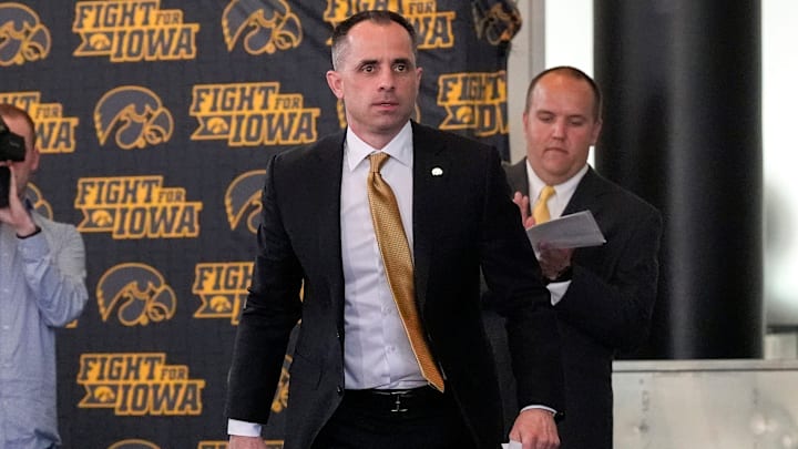 Ben McCollum, Iowa's new head men's basketball coach, walks to the podium during his introductory press conference Tuesday, March 25, 2025 at Carver-Hawkeye Arena in Iowa City, Iowa.