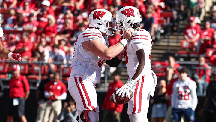 Oct 12, 2024; Piscataway, New Jersey, USA; Wisconsin Badgers running back Darrion Dupree (13) celebrates his touchdown run with offensive lineman Jake Renfro (57) during the second half against the Rutgers Scarlet Knights at SHI Stadium. Oct 12, 2024; Piscataway, New Jersey, USA; Wisconsin Badgers running back Darrion Dupree (13) celebrates his touchdown run with offensive lineman Jake Renfro (57) during the second half against the Rutgers Scarlet Knights at SHI Stadium.