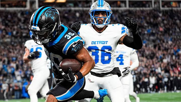 Carolina Panthers running back Chuba Hubbard (30) runs for a touchdown against Detroit Lions safety Chuck Clark (36) Carolina Panthers running back Chuba Hubbard (30) runs for a touchdown against Detroit Lions safety Chuck Clark (36)