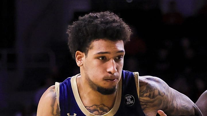 Nov 16, 2025; Cincinnati, Ohio, USA; Mount St. Mary's Mountaineers forward Luke McEldon (21) drives to the basket against Cincinnati Bearcats center Moustapha Thiam (52) in the second half at Fifth Third Arena. Mandatory Credit: Katie Stratman-Imagn Images Nov 16, 2025; Cincinnati, Ohio, USA; Mount St. Mary's Mountaineers forward Luke McEldon (21) drives to the basket against Cincinnati Bearcats center Moustapha Thiam (52) in the second half at Fifth Third Arena. Mandatory Credit: Katie Stratman-Imagn Images