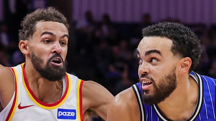 Orlando Magic guard Tyus Jones drives to the basket against Atlanta Hawks guard Trae Young.