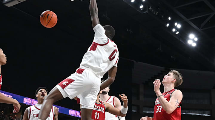 Nov 21, 2024; Spokane, Washington, USA; Washington State Cougars guard Cedric Coward (0) dunks the ball against Eastern Washington Eagles forward Emmett Marquardt (33) in the second half at Spokane Veterans Memorial Arena. Washington State Cougars won 96-81. Mandatory Credit: James Snook-Imagn Images Nov 21, 2024; Spokane, Washington, USA; Washington State Cougars guard Cedric Coward (0) dunks the ball against Eastern Washington Eagles forward Emmett Marquardt (33) in the second half at Spokane Veterans Memorial Arena. Washington State Cougars won 96-81. Mandatory Credit: James Snook-Imagn Images