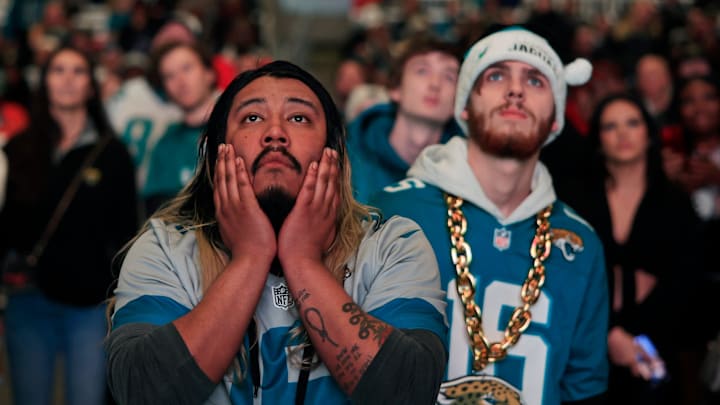 Jacksonville Jaguars fans Griffin Lasch, center, and Garrett Roberson, right, react to costly mistakes during the second half Saturday, Jan 21, 2023 at TIAA Bank Field's Dream Finders Homes Flex Field at Daily's Place in Jacksonville, Fla. 