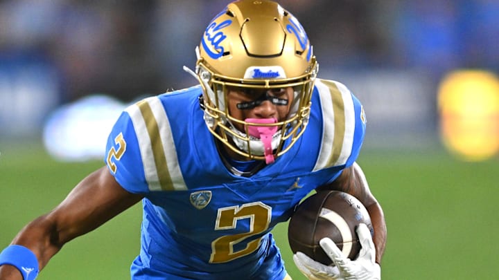 Sep 30, 2022; Pasadena, California, USA; UCLA Bruins wide receiver Titus Mokiao-Atimalala (2) carries the ball in the first half against the Washington Huskies at the Rose Bowl. Mandatory Credit: Jayne Kamin-Oncea-Imagn Images