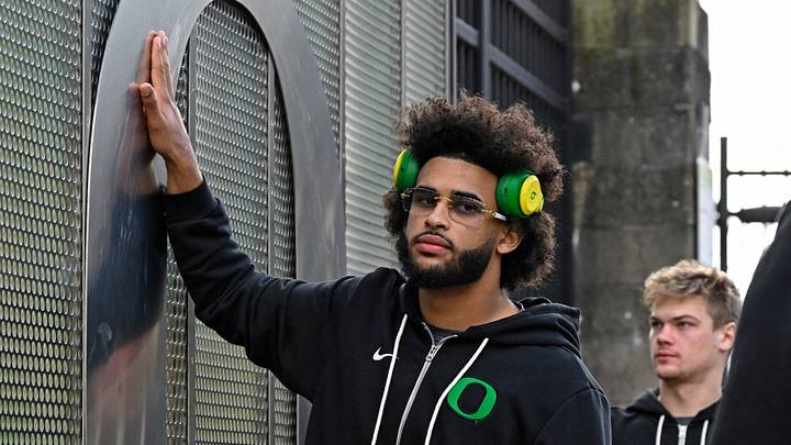 Nov 22, 2025; Eugene, Oregon, USA; Oregon Ducks quarterback Dante Moore (5) touches medal O during the march march before the game against the Southern California Trojans at Autzen Stadium. 