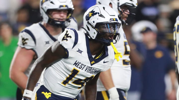 West Virginia Mountaineers quarterback Khalil Wilkins (14) makes calls during the second half of the game against Kansas Jayhawks at David Booth Kansas Memorial Stadium on Sept. 20, 2025.