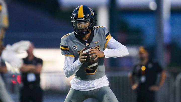 American Heritage Patriots quarterback Dia Bell (3) scrambles in the backfield during the first quarter of a game against the Naples Golden Eagles at Staver Field in Naples on Friday, Sept. 13, 2024.