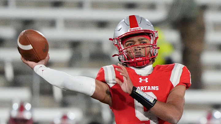 Saraland's KJ Lacey (9) thows a pass as he is pressured by a Parker defender. 