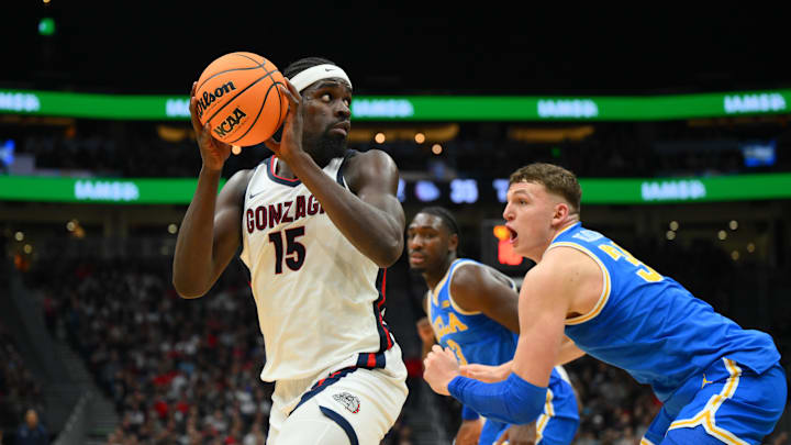Dec 13, 2025; Seattle, Washington, USA; Gonzaga Bulldogs forward Graham Ike (15) is guarded by UCLA Bruins forward Tyler Bilodeau (34).