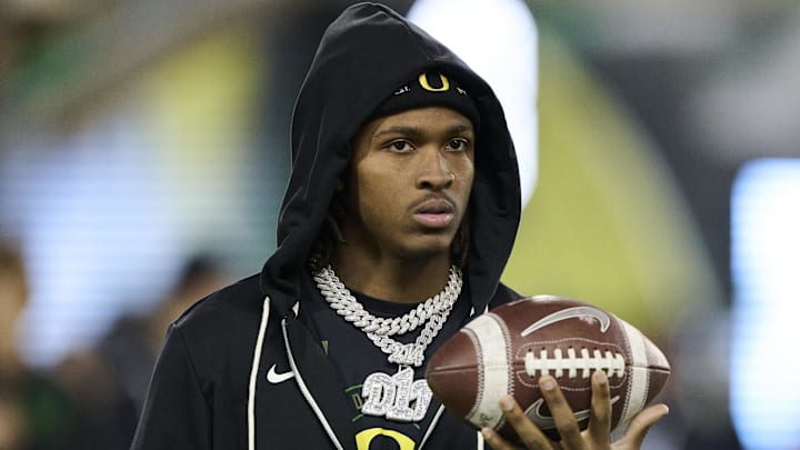 Nov 14, 2025; Eugene, Oregon, USA; Oregon Ducks wide receiver Dakorien Moore (1) watches teammates warm up before a game against the Minnesota Golden Gophers at Autzen Stadium. 