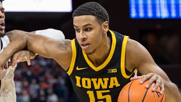 Nov 29, 2021; Charlottesville, Virginia, USA; Iowa Hawkeyes forward Keegan Murray (15) drives to the basket against Virginia Cavaliers forward Jayden Gardner (1) during the first half at John Paul Jones Arena. Mandatory Credit: Scott Taetsch-Imagn Images