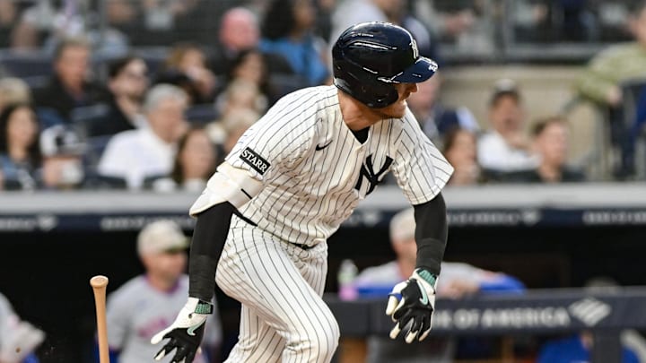 May 16, 2025; Bronx, New York, USA; New York Yankees outfielder Cody Bellinger (35) hits an infield single against the New York Mets during the third inning at Yankee Stadium. Mandatory Credit: John Jones-Imagn Images