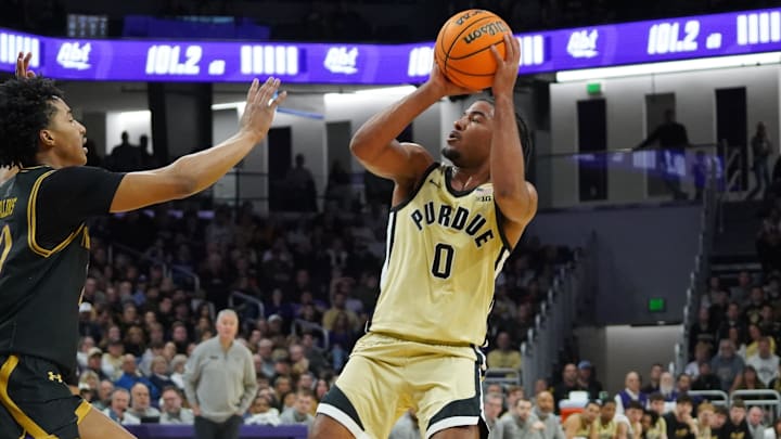 Purdue Boilermakers guard C.J. Cox (0) shoots the ball over Northwestern Wildcats guard Justin Mullins (20).