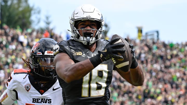 Sep 20, 2025; Eugene, Oregon, USA; Oregon Ducks tight end Kenyon Sadiq (18) makes a reception Oregon State Beavers defensive back Tyrice Ivy Jr. (12) of the game at Autzen Stadium. Sadiq scored a touchdown on the play. Mandatory Credit: Troy Wayrynen-Imagn Images