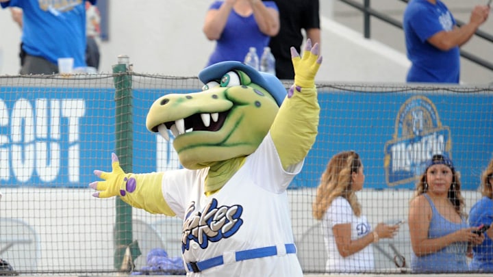 Rancho Cucamonga Quakes mascot Tremor walks beside fans at LoanMart Field. 