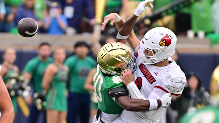Sep 28, 2024; South Bend, Indiana, USA; Louisville Cardinals quarterback Tyler Shough (9) is hit as he throws by Notre Dame Fighting Irish defensive lineman Loghan Thomas (10) in the fourth quarter at Notre Dame Stadium. Mandatory Credit: Matt Cashore-Imagn Images Sep 28, 2024; South Bend, Indiana, USA; Louisville Cardinals quarterback Tyler Shough (9) is hit as he throws by Notre Dame Fighting Irish defensive lineman Loghan Thomas (10) in the fourth quarter at Notre Dame Stadium. Mandatory Credit: Matt Cashore-Imagn Images