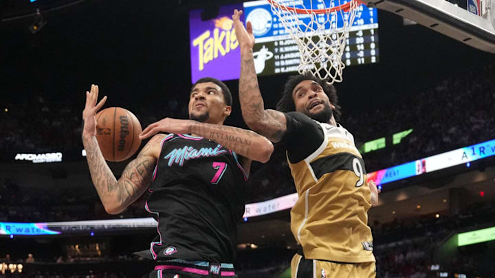 Apr 4, 2026; Miami, Florida, USA;  Miami Heat center Kel'el Ware (7) collects a rebound as Washington Wizards forward Justin Champagnie (9) looks on during the second half at Kaseya Center. Mandatory Credit: Jim Rassol-Imagn Images