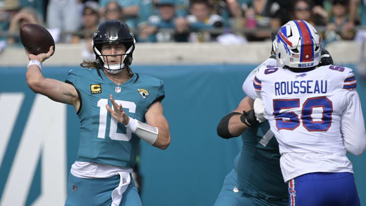 Jacksonville Jaguars' quarterback Trevor Lawrence (16) and Buffalo Bills' defensive end Greg Rousseau (50)