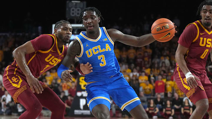 Jan 27, 2025; Los Angeles, California, USA; UCLA Bruins guard Eric Dailey Jr. (3) dribbles the ball against Southern California Trojans guard Chibuzo Agbo (7) and forward Saint Thomas (0) in the first half at Galen Center. Mandatory Credit: Kirby Lee-Imagn Images
