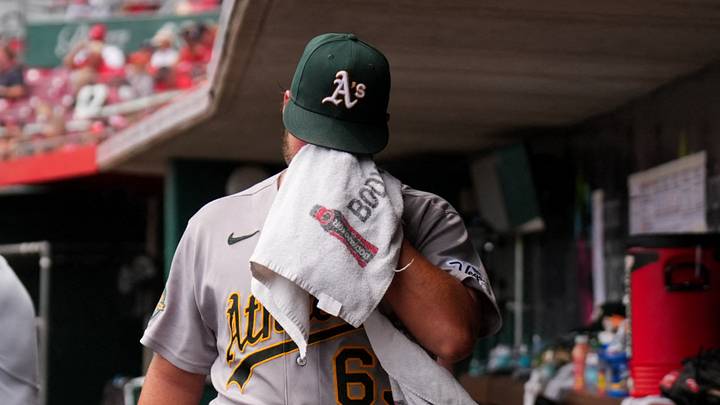 Aug 6, 2026; Cincinnati, Ohio, USA;  Athletics' pitcher Mason Barnett walks in the dugout after being removed from the game against the Cincinnati Reds in the fifth inning at Great American Ball Park. Mandatory Credit: Aaron Doster-Imagn Images