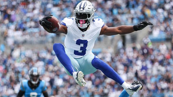Dallas Cowboys wide receiver George Pickens jumps over Carolina Panthers safety Nick Scott. Dallas Cowboys wide receiver George Pickens jumps over Carolina Panthers safety Nick Scott.